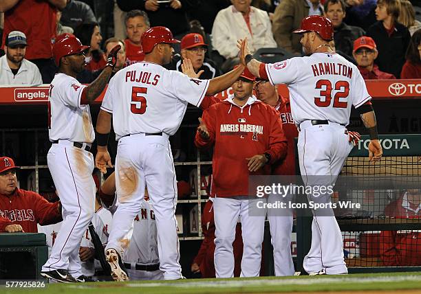 Los Angeles Angels of Anaheim Albert Pujols greets Josh Hamilton after Pujols scored on a Hamilton hit during a game against the Seattle Mariners...