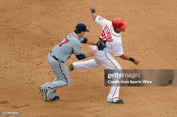 Washington Nationals shortstop Ian Desmond is tagged out in a run down as Atlanta Braves starting pitcher David Hale makes the tag at Nationals Park...