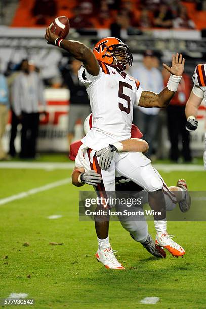 Virginia Tech Hokies Quarterback Tyrod Taylor throws the ball under pressure from Stanford Cardinal Linebacker Ben Gardner during the first half of...