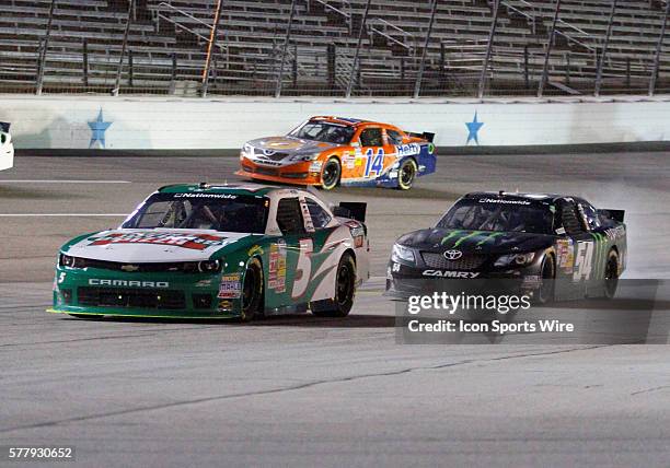 Nationwide Series driver Kevin Harvick and Nationwide Series driver Kyle Busch drive down pit lane for a pit stop during a caution during the NASCAR...