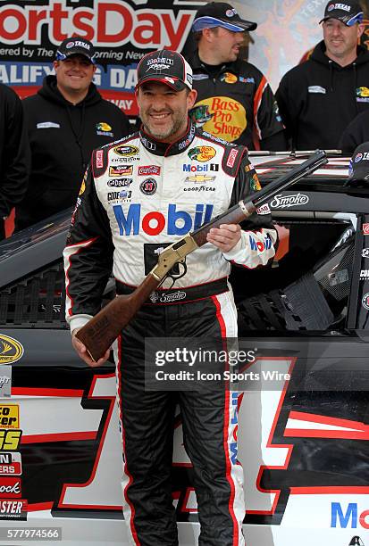 Tony Stewart celebrates winning the pole for the NASCAR Sprint Cup Series Duck Commander 500 at Texas Motor Speedway in Ft. Worth, TX.