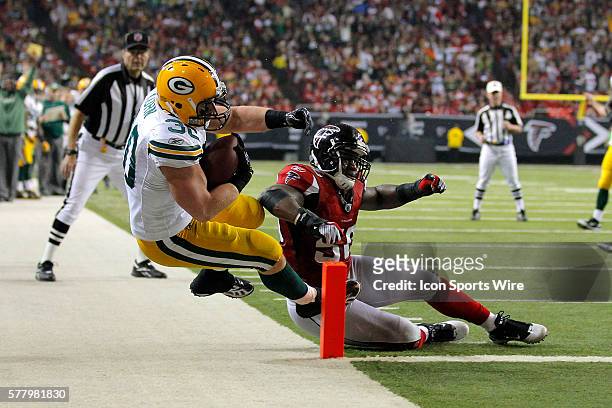 Green Bay Packers fullback John Kuhn scores as he is hit at the goal line by Atlanta Falcons linebacker Curtis Lofton in the Green Bay Packers 48-21...