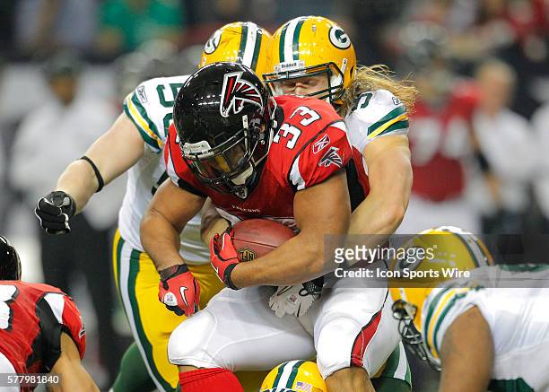 Atlanta Falcons running back Michael Turner is hit by Green Bay Packers linebacker Clay Matthews in the Green Bay Packers 48-21 victory over the...