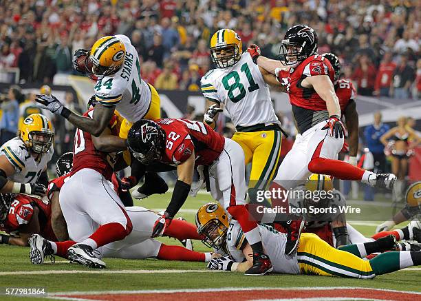 Green Bay Packers running back James Starks is hit as he dives for the endzone by Atlanta Falcons linebacker Coy Wire denying the endzone in first...