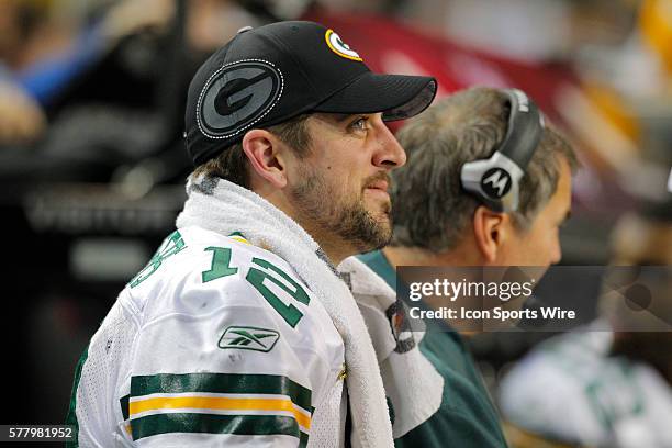 Green Bay Packers quarterback Aaron Rodgers smiles on the bench as the final minutes tick away in the Green Bay Packers 48-21 victory over the...