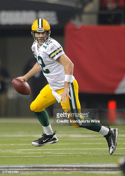 Green Bay Packers quarterback Aaron Rodgers rolls out to pass in the Green Bay Packers 48-21 victory over the Atlanta Falcons in the NFC Divisional...