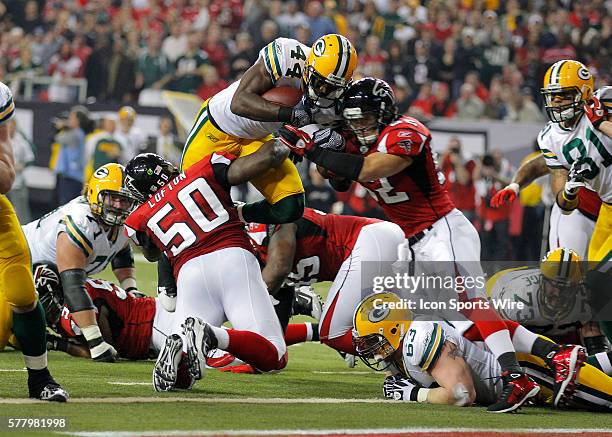 Green Bay Packers running back James Starks is hit as he dives for the endzone by Atlanta Falcons linebacker Coy Wire and linebacker Curtis Lofton...