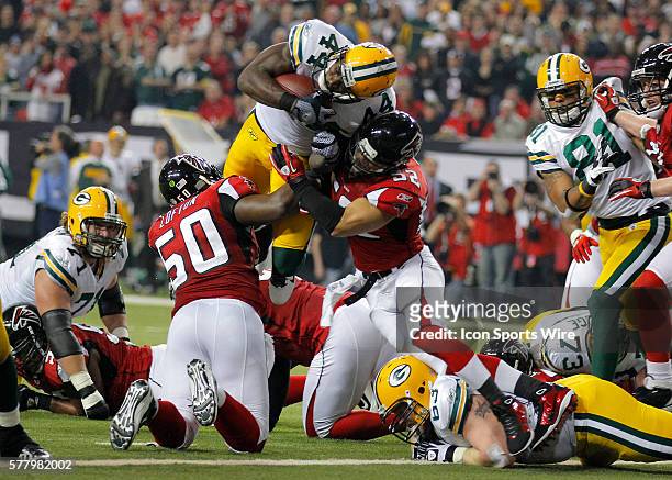 Green Bay Packers running back James Starks is hit as he dives for the endzone by Atlanta Falcons linebacker Coy Wire and linebacker Curtis Lofton...
