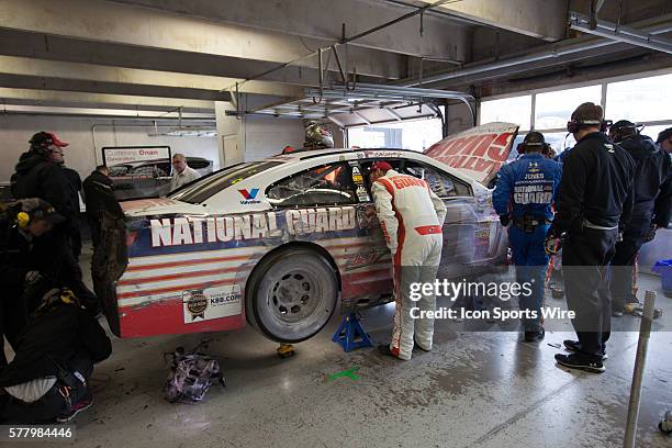 Dale Earnhardt Jr., driver of the National Guard Chevrolet assesses the damage to his car after catching the splitter in the grass on the third lap...