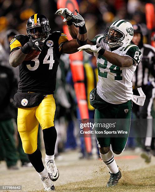 Pittsburgh Steelers running back Rashard Mendenhall fends off New York Jets cornerback Darrelle Revis in the first half of the AFC Championship game...