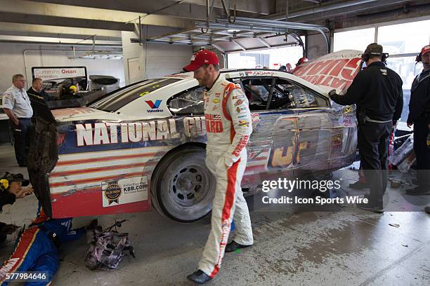 Dale Earnhardt Jr., driver of the National Guard Chevrolet assesses the damage to his car after catching the splitter in the grass causing him to hit...