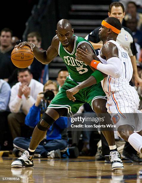 Boston Celtics power forward Kevin Garnett dribbles against Charlotte Bobcats shooting guard Stephen Jackson during an NBA basketball game at Time...