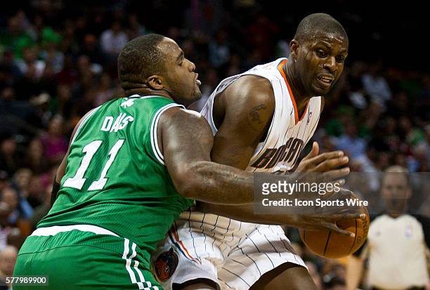 Charlotte Bobcats center Nazr Mohammed works to drive against Boston Celtics power forward Glen Davis during an NBA basketball game at Time Warner...