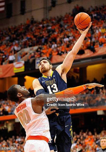 West Virginia Mountaineers forward Deniz Kilicli takes a shot over Syracuse Orange forward Rick Jackson during the second half at the Carrier Dome in...