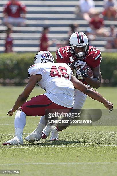Back Rod Tally on a run play tackled by Spur back Cedrick Malone during the spring practice game held at Williams-Brice Stadium, in Columbia, South...