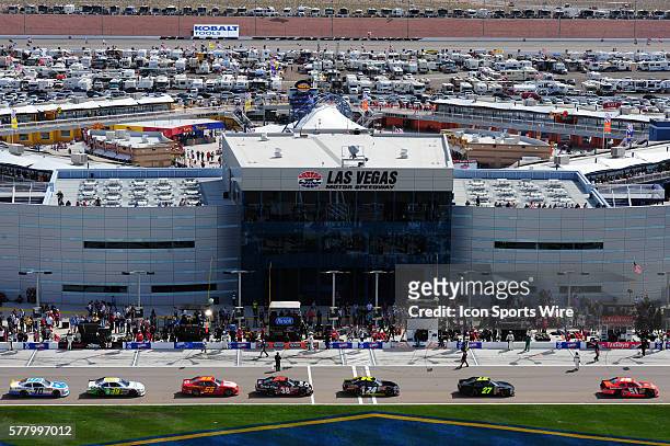 The cars leave pit row after starting their engines during the NASCAR Nationwide Series Sam's Town 300 at the Las Vegas Motor Speedway in Las Vegas,...