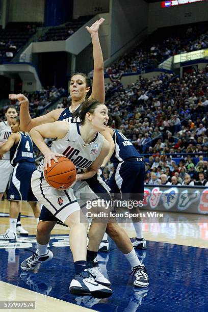 Connecticut Huskies guard Kelly Faris looks for an opening along the baseline against Notre Dame Fighting Irish forward Becca Bruszewski during the...