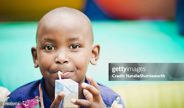 young boy drinking a juice box - juice box stock pictures, royalty-free photos & images