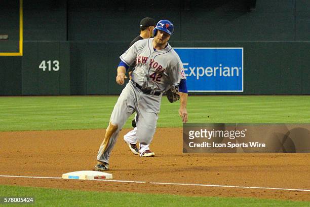 New York Mets outfielder Andrew Brown rounds third base on his way to score during the game between the New York Mets and the Arizona Diamondbacks at...