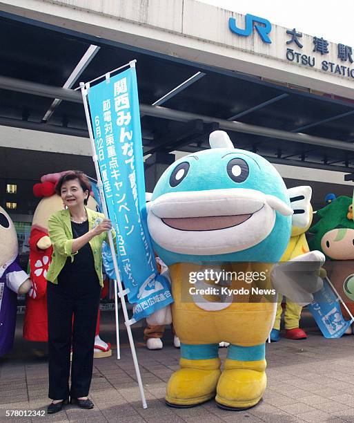 Japan - Shiga Gov. Yukiko Kada calls for power saving with Kyaffi, a mascot character for the western Japan prefecture themed on catfish in Lake Biwa...