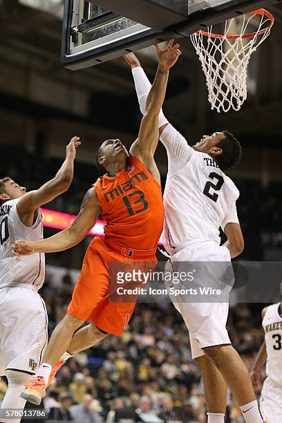 Miami Hurricanes guard Angel Rodriguez tries for the basket guarded by Wake Forest Demon Deacons forward Devin Thomas under the rim during the ACC...