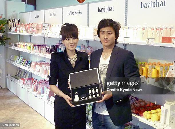 Japan - South Korean soccer player Ahn Jung Hwan and his wife visit Girls Up, a store for popular South Korean cosmetics products, in Osaka on June...