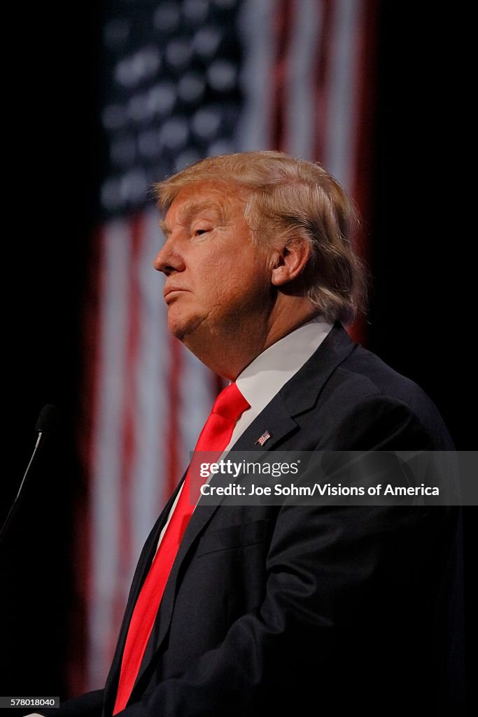 Republican Presidential Candidate Donald Trump Profile And Flag At Campaign Event