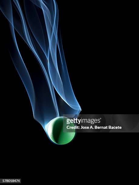 sphere surrounded with smoke in free fall on a black background - sinus stockfoto's en -beelden