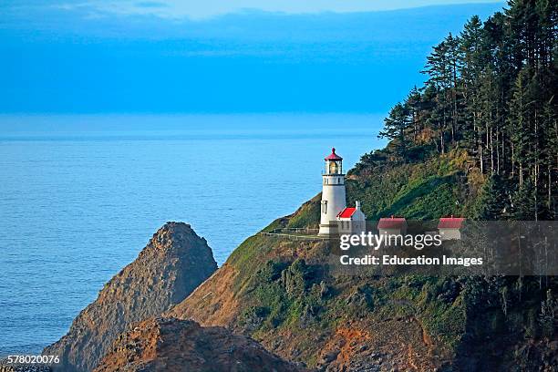 Historic Haceta Head lighthouse built in 1894 on the south central Oregon coast north of Florence shines its light out over the Pacific Ocean.