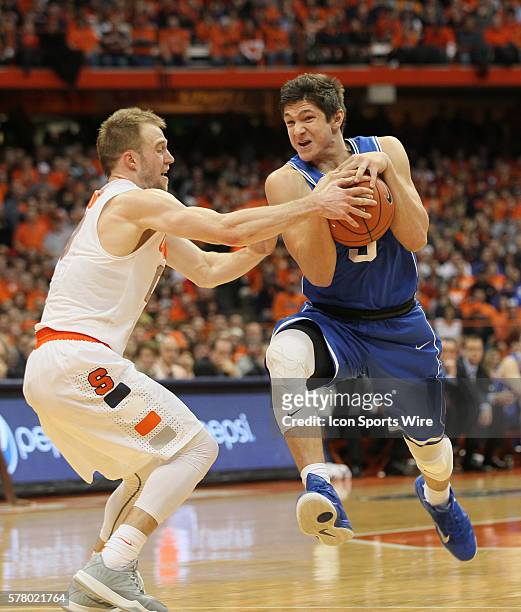 Duke Blue Devils guard Grayson Allen is fouled by Syracuse Orange guard Trevor Cooney during ncaa basketball game between Duke Blue Devils and...