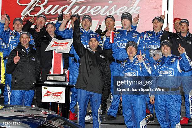 Jimmie Johnson celebrates winning the NASCAR Sprint Cup Series Budweiser Duel race at Daytona International Speedway in Daytona, Florida