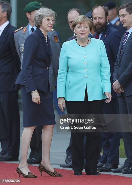 German Chancellor Angela Merkel and British Prime Minister Theresa May meet each other's government representatives upon May's arrival at the...