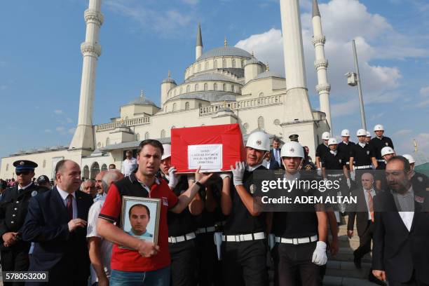 Turkish honor guard carries the coffin of a policeman killed during the failed July 15 coup attempt, during a funeral ceremony at Kocatepe mosque in...