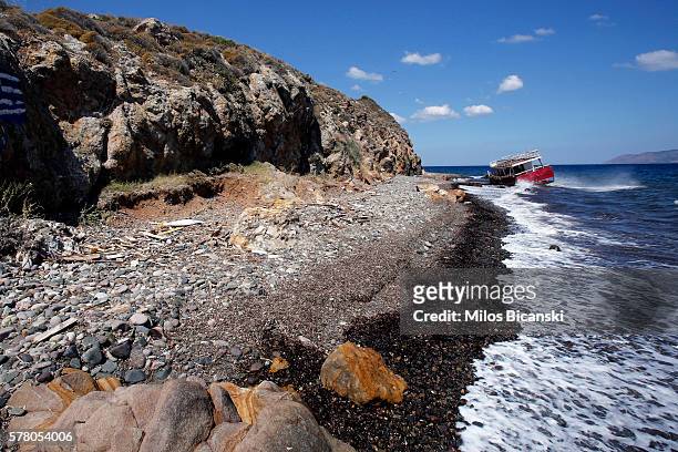 The wrecked remains of a ship lie on the shore on the beach of Skala Kaminas which was used by refugees to cross Aegean sea from Turkey to Greece...