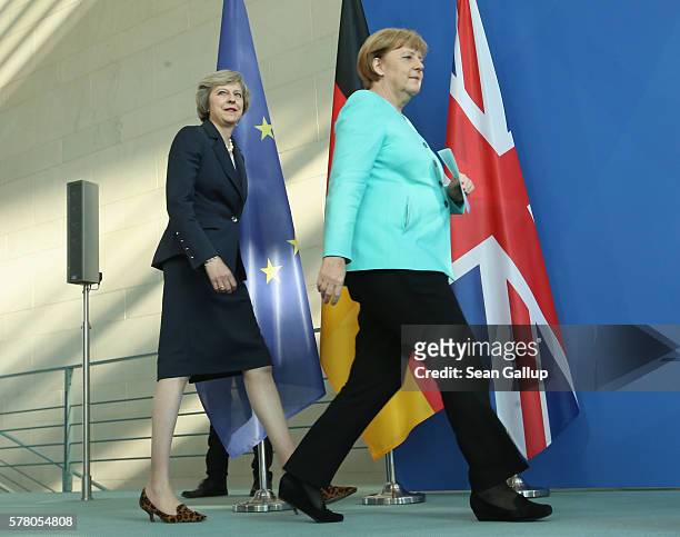 German Chancellor Angela Merkel and British Prime Minister Theresa May arrive to speak to the media following talks at the Chancellery on July 20,...