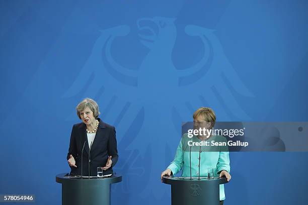 German Chancellor Angela Merkel and British Prime Minister Theresa Mayspeak to the media under the German Federal Eagle following talks at the...