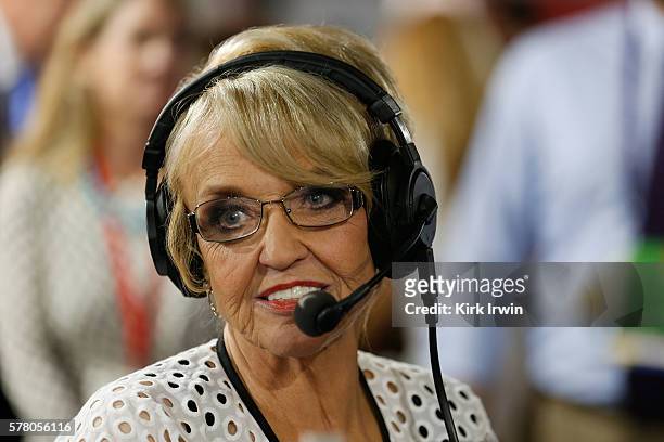 Former Arizona Governor Jan Brewer talks with Tim Farley as he records an episode of "Midday Briefing" on SiriusXM POTUS at Quicken Loans Arena on...