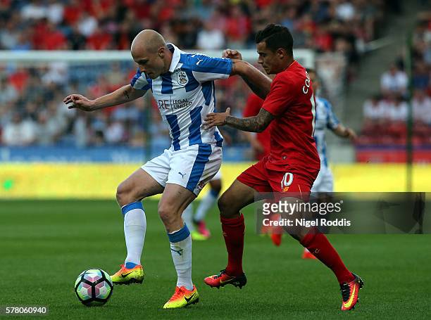 Aaron Mooy of Huddersfield Town challenged by Philippe Coutinho of Liverpool during the Pre-Season Friendly match between Huddersfield Town and...