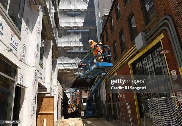 Construction workers work on a mixed use project in downtown Denver, July 20, 2016. The Dairy Block project is building adding housing and a hotel to...
