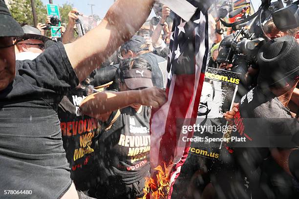 Group tries to burn an American flag as police move in near the site of the Republican National Convention in downtown Cleveland on the third day of...