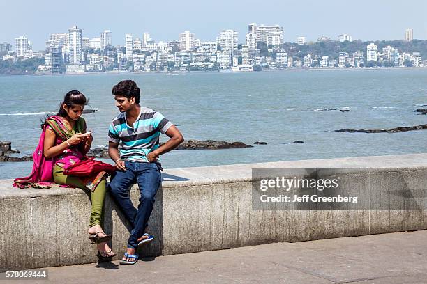 India Mumbai Churchgate Marine Drive Back Bay Arabian Sea man woman couple romantic Malabar Hill skyline buildings.