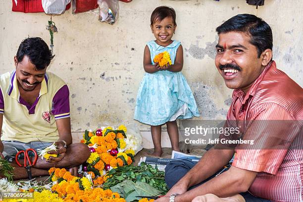 India Mumbai Apollo Bandar Colaba Causeway Market Lala Nigam Road shopping street vendors flower flowers man father girl daughter.