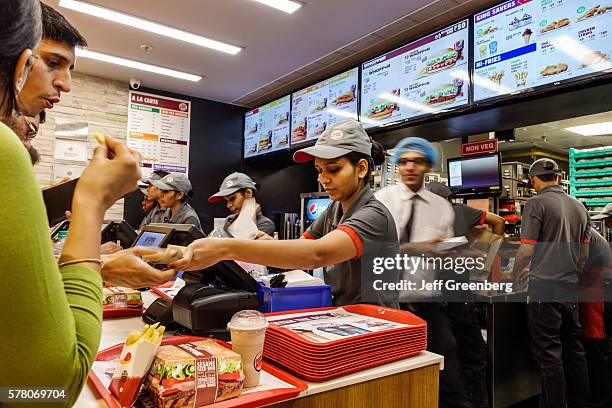 India Mumbai Lower Parel High Street Phoenix mall inside restaurant Burger King fast food counter woman man coworkers employee working customer...