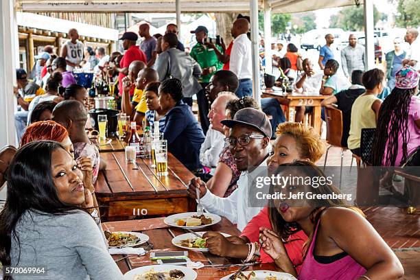 South Africa Johannesburg Soweto Vilakazi Street Precinct Sakhumzi restaurant woman man friends eating.