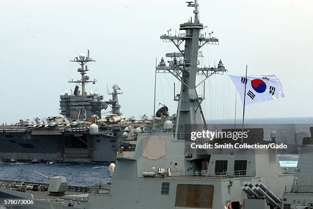 The aircraft carrier USS George Washington CVN 73 and the Republic of Korea navy destroyer ROKS Sejong the Great DDG 991 participate in a trilateral...