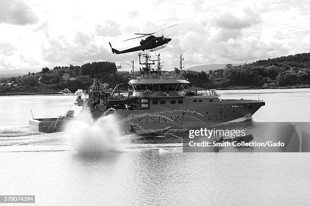 The crew of Royal Norwegian Coast Guard patrol boat KV Tor W334 simulates being a skiff taken over by pirates as Royal Norwegian Marinejaggers use...