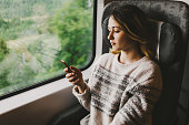 Woman in train with smartphone