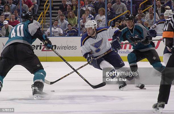 Mike Eastwood of the St. Louis Blues is pursued by Stephane Matteau of the San Jose Sharks during game 1 of the western conference playoffs at the...