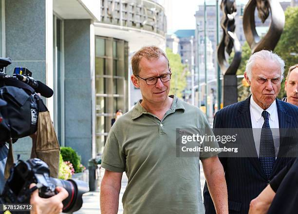 Mark Johnson, global head of foreign exchange cash trading in London HSBC Holdings Plc, center, leaves federal district court in the Brooklyn borough...