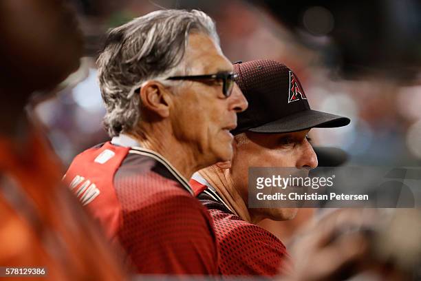Manager Chip Hale and first base coach Dave McKay of the Arizona Diamondbacks watch from the dugout during the ninth inning of the interleague MLB...
